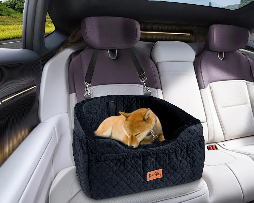 A small dog asleep in a black Vivifying car seat strapped to a rear seat